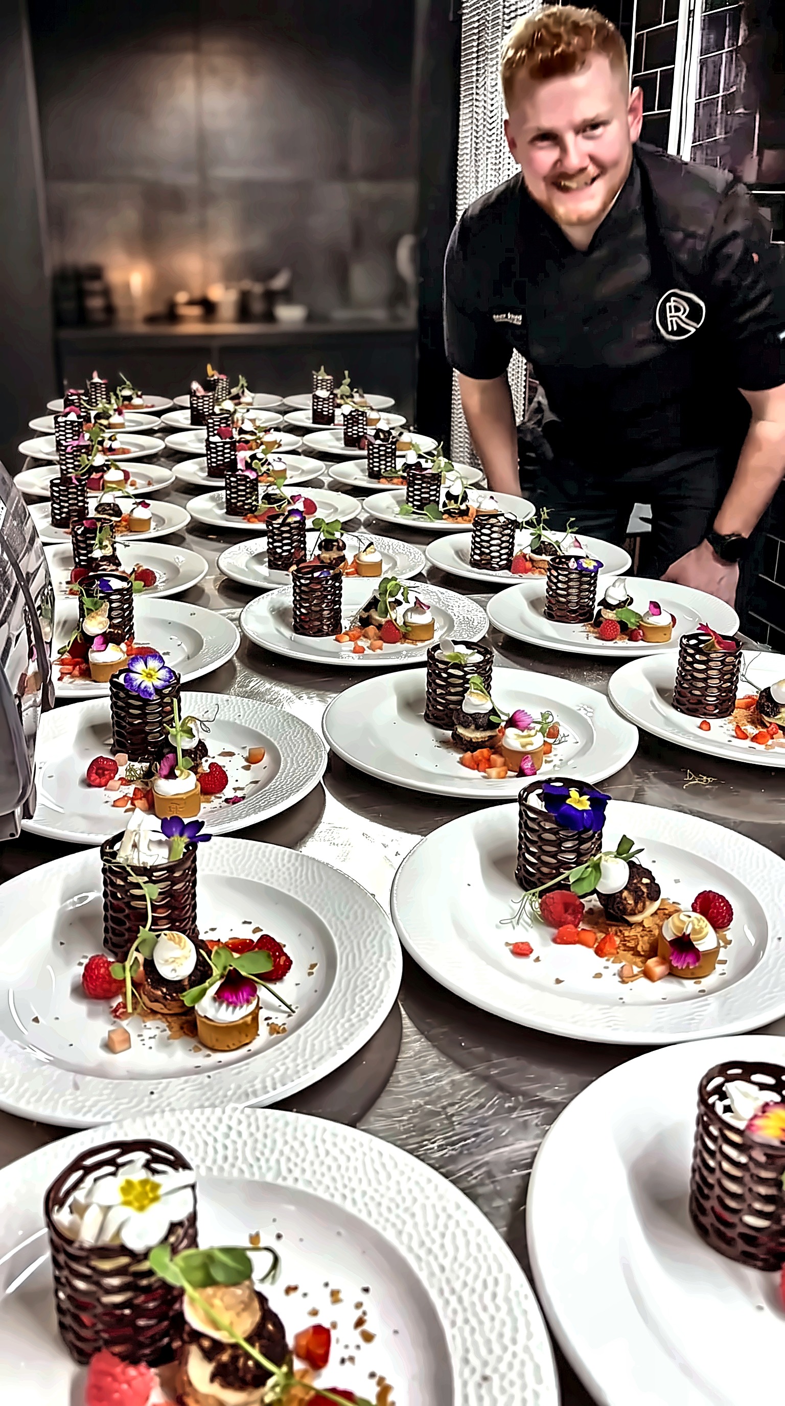 Chef plating a banquet of signature desserts in the kitchen