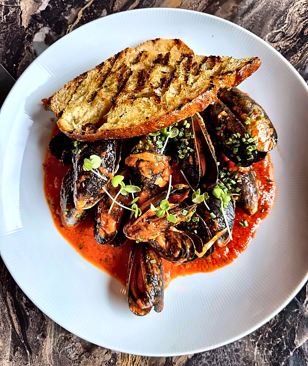 Mussels in spiced tomato sauce with grilled sourdough